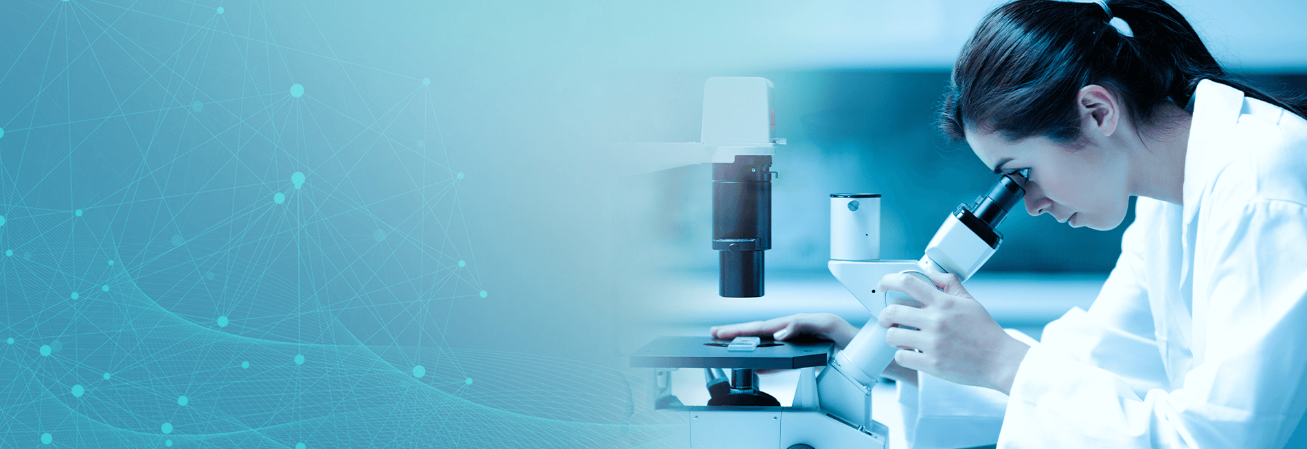 Lab technician looking at samples through a microscope